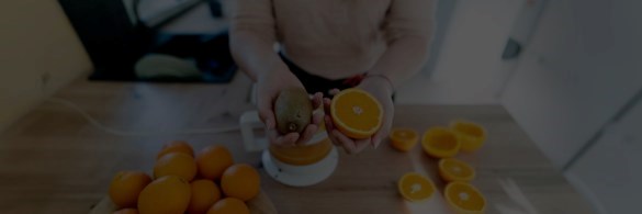 Person cutting up oranges on their kitchen counter