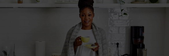 Healthy woman warmly dressed in her kitchen