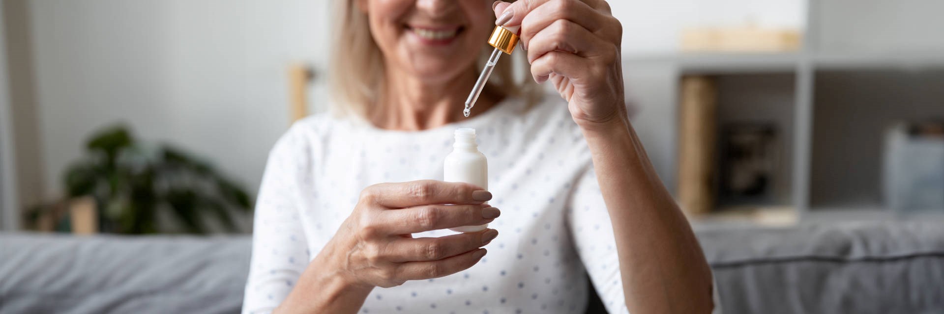 Woman with product in dropper bottle