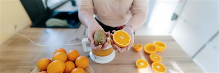 Person chopping up and juicing fruit