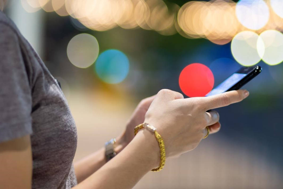 Woman in dark conditions looking at her phone